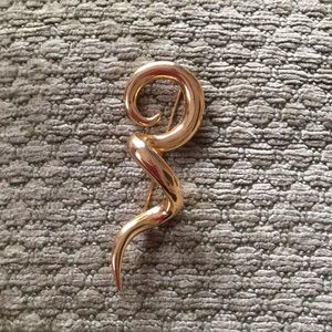 Gold colored abstract pin